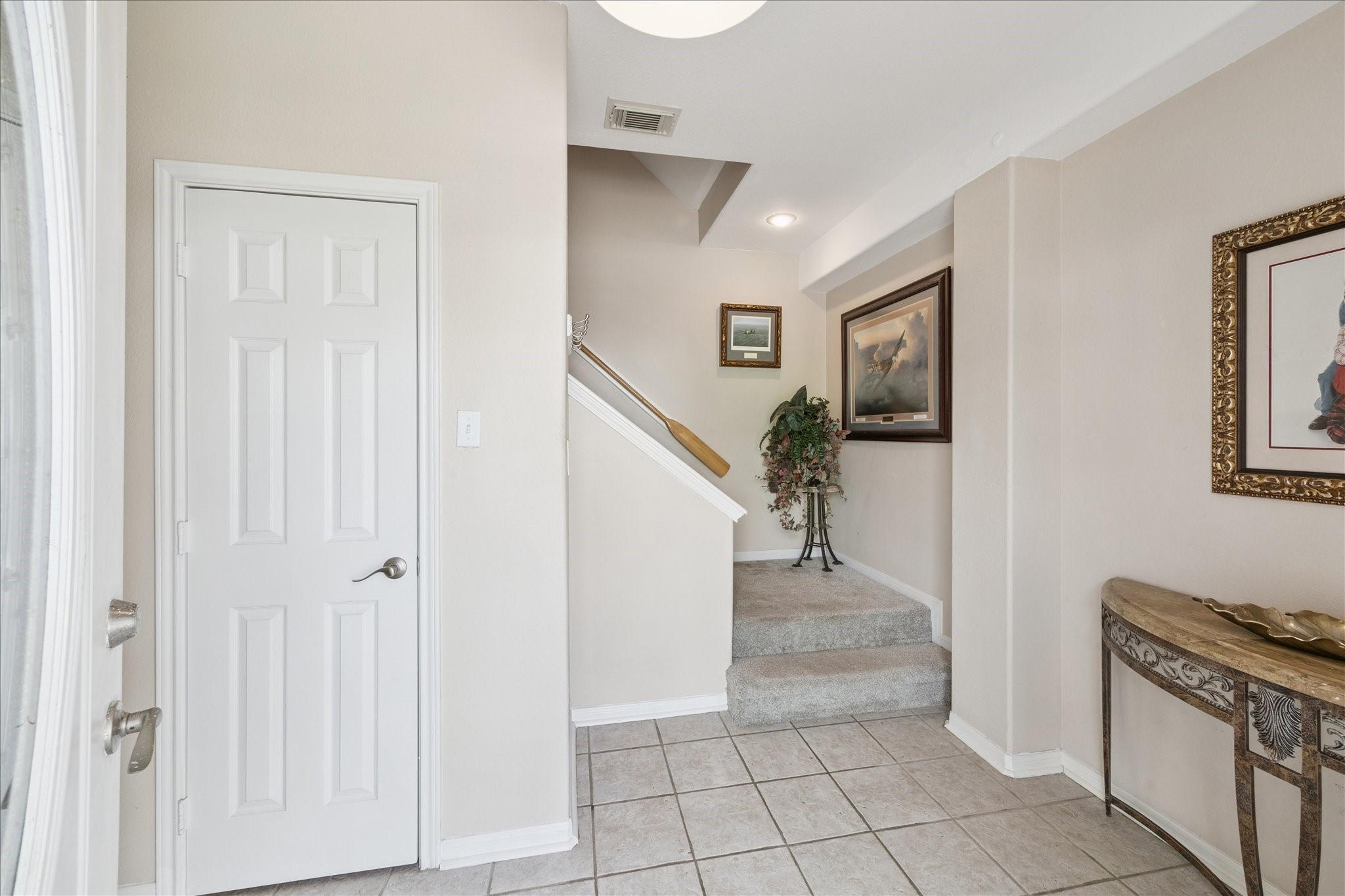 Image 3: Here is a well-lit entryway with tiled floors lead