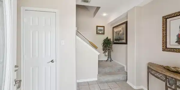 Image 3: Here is a well-lit entryway with tiled floors lead