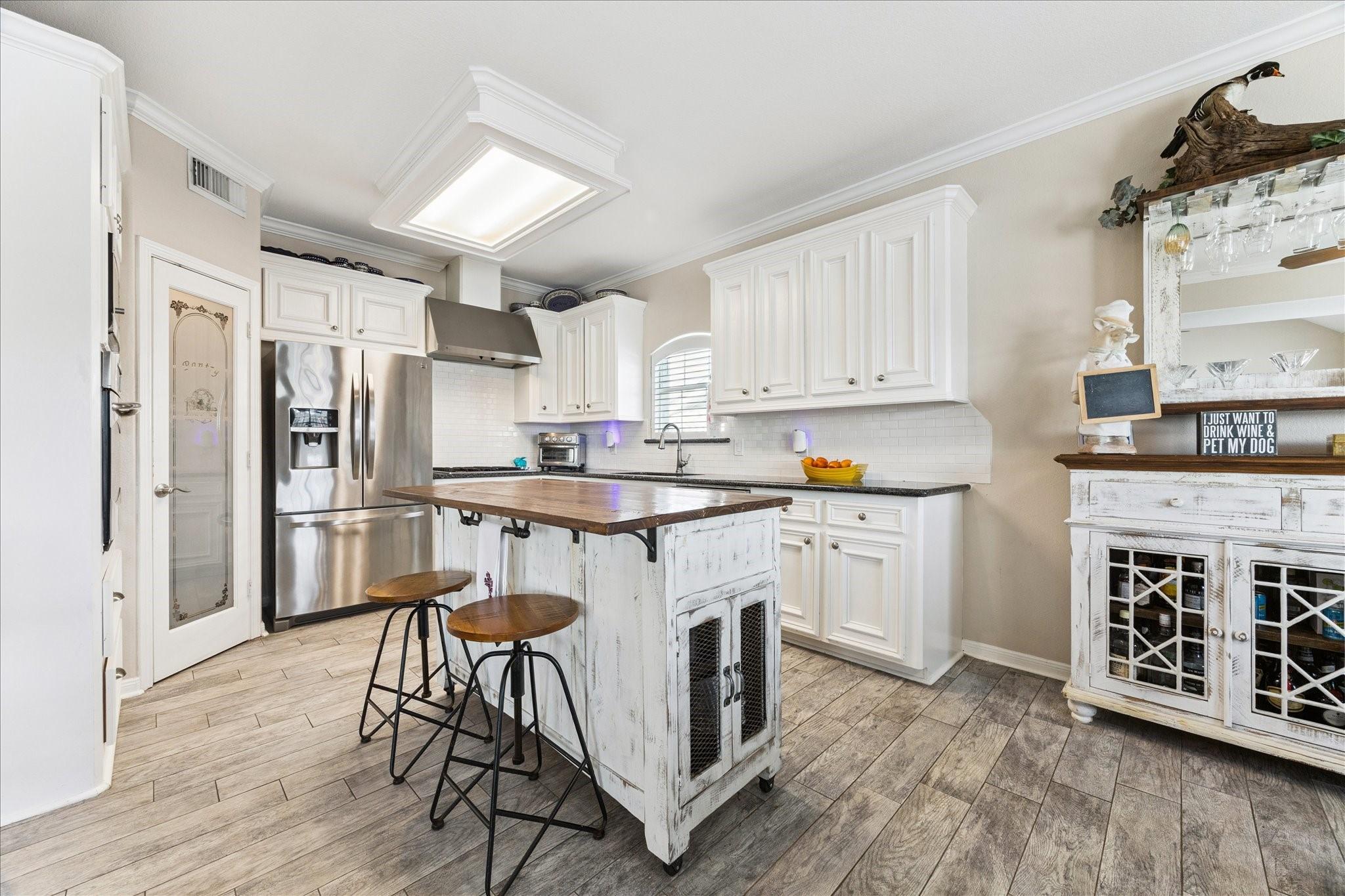 Image 4: This kitchen features a modern rustic design with