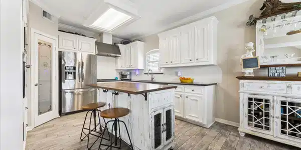 Image 4: This kitchen features a modern rustic design with