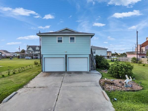 Image 3: Front of house facing south, double driveway and g
