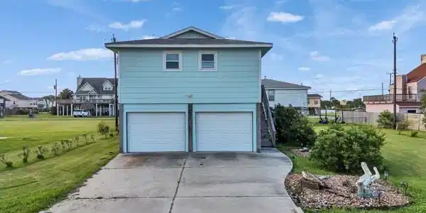 Image 3: Front of house facing south, double driveway and g