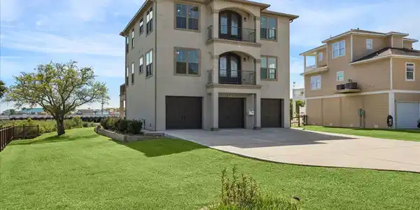 Image 2: The property includes a large side yard that overl