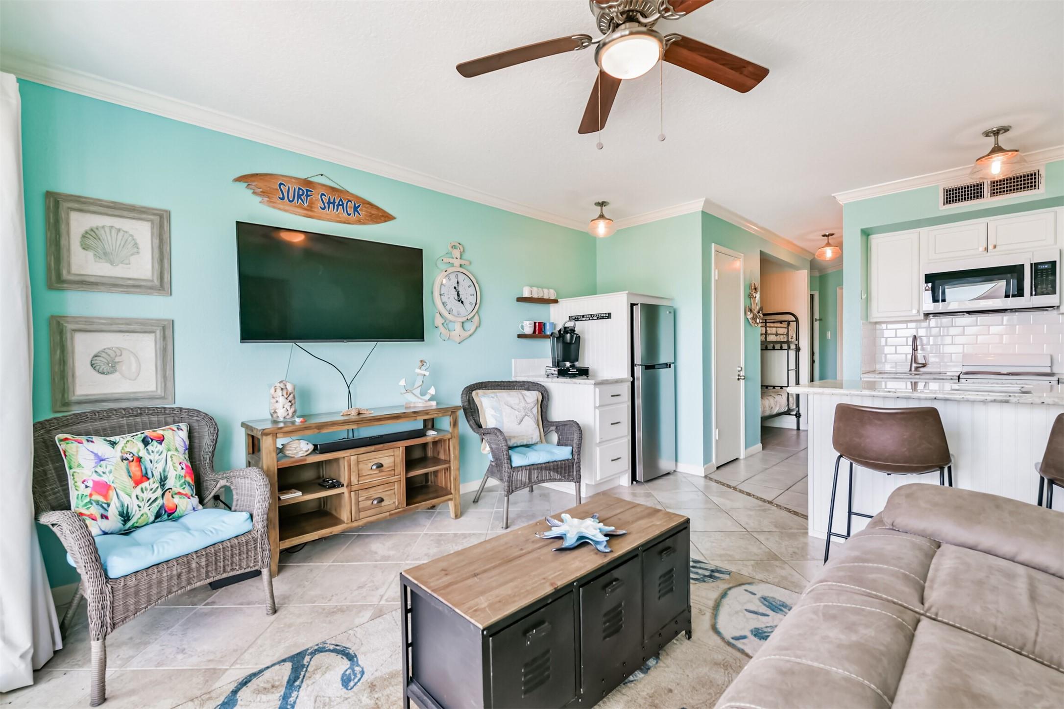 Image 3: Comfortable main living space with breakfast bar a