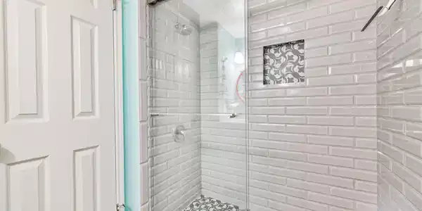 Image 4: Updated shower with glass door, subway-style tile,