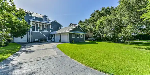 Image 3: Stunning home with elegant gray siding, a spacious