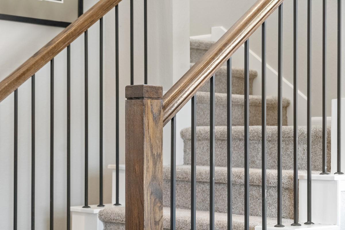 Image 2: Elegant staircase featuring rich stained wood hand