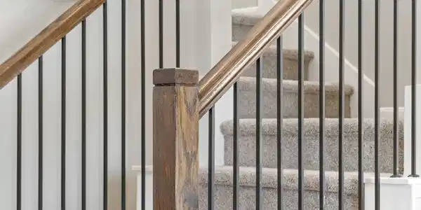 Image 2: Elegant staircase featuring rich stained wood hand