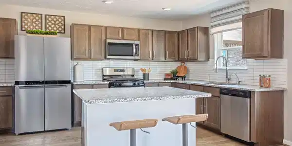 Image 4: This spacious kitchen offers rich wood cabinetry,