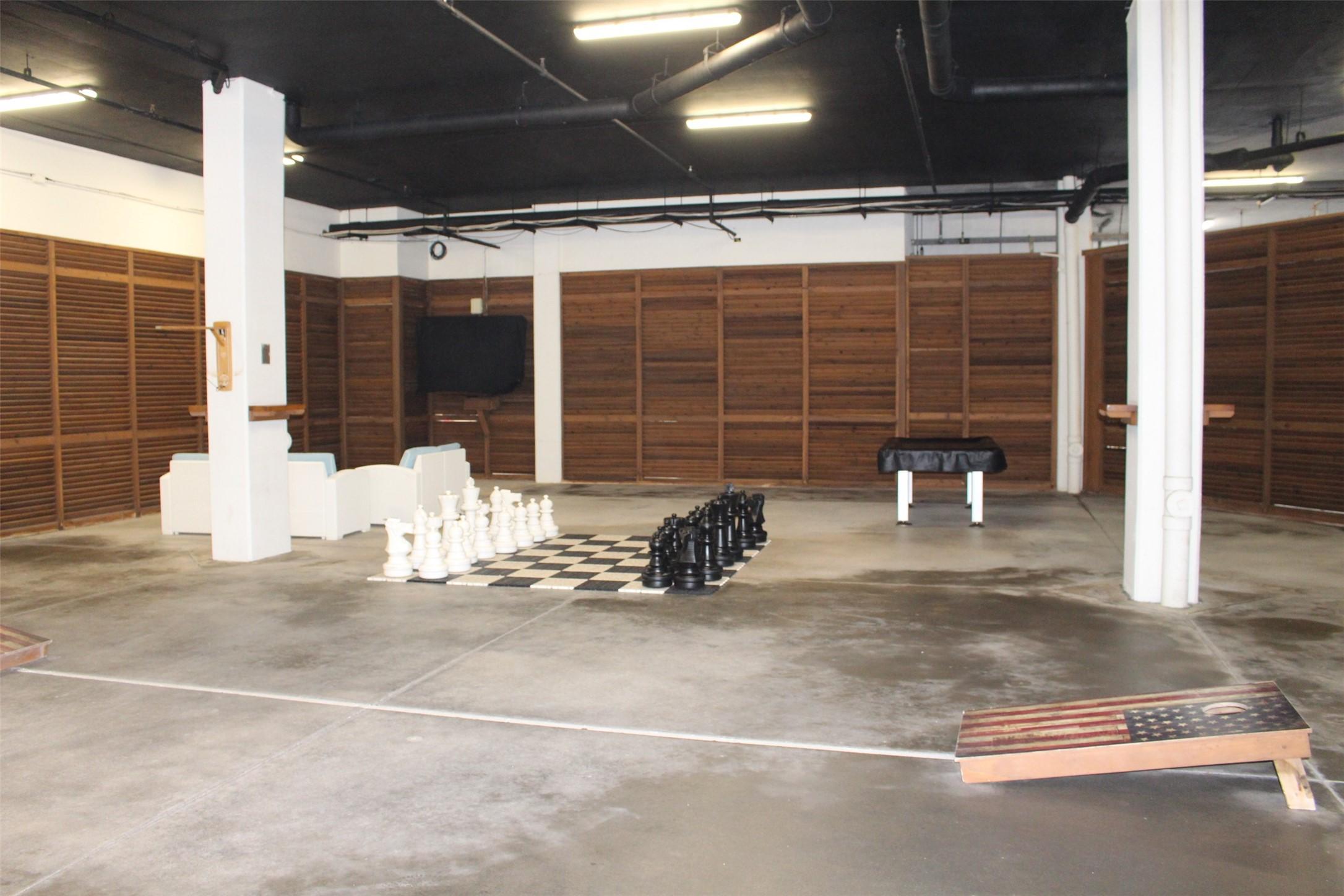 Image 2: Covered "fun space" @ ground level. Pool table, co