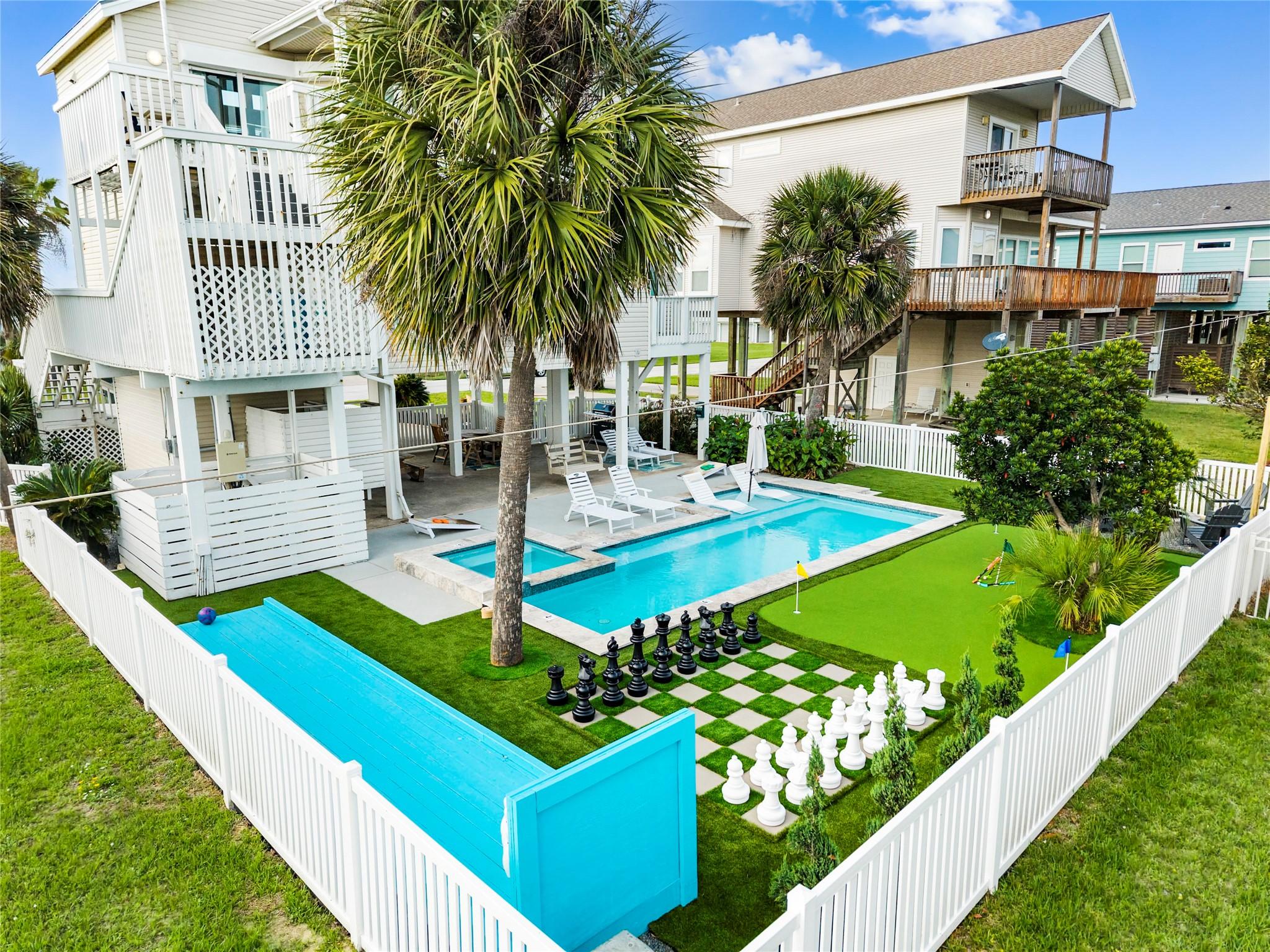 Image 3: Stunning backyard oasis with fenced pool area, tro