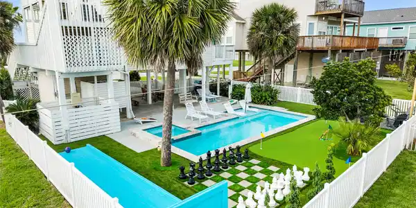 Image 3: Stunning backyard oasis with fenced pool area, tro