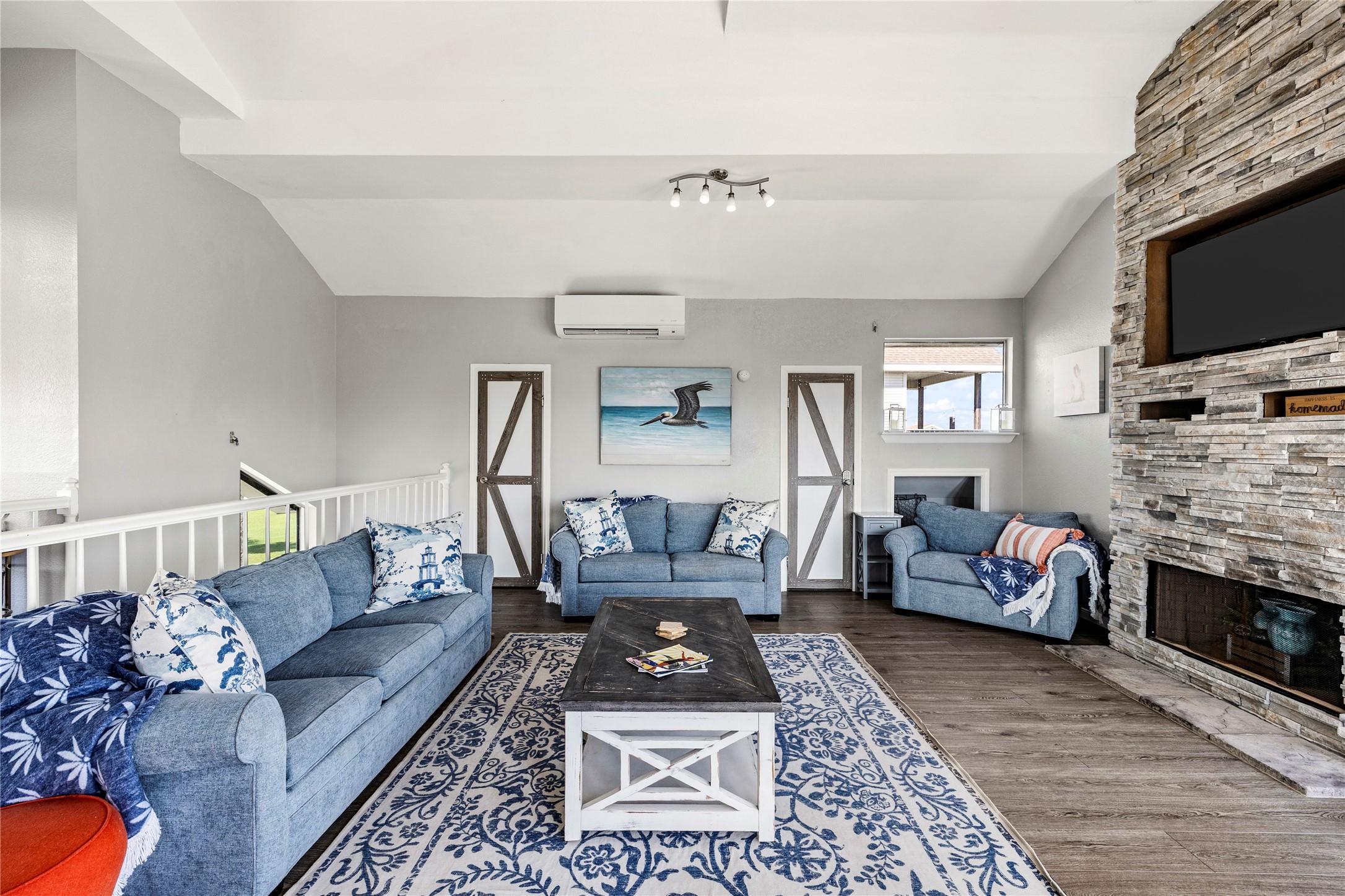 Image 4: Bright open-concept living room with plush seating