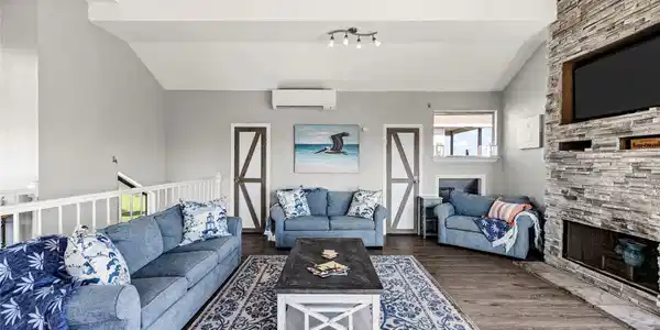 Image 4: Bright open-concept living room with plush seating