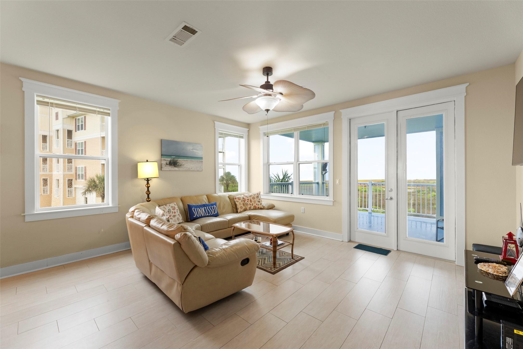 Image 4: Living area with plenty of natural light. Steps aw