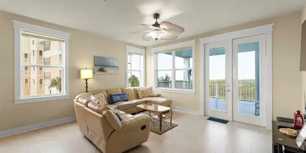 Image 4: Living area with plenty of natural light. Steps aw