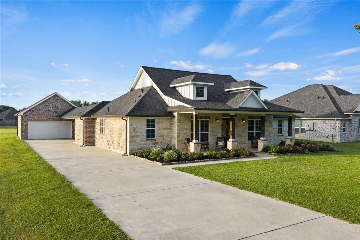 Image 4: Large home with a detached garage.