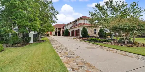 Image 3: Long extended driveway leading to the four-car gar