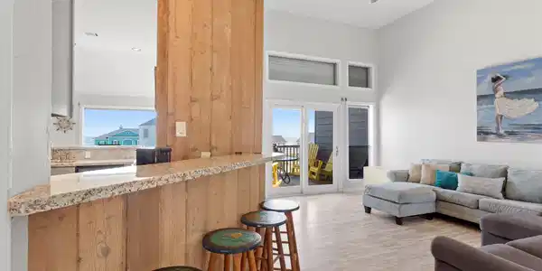 Image 3: Cozy bar area opens to roomy living space with wal