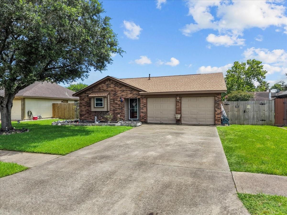 Image 2: Front exterior showcasing mature shade tree, attra
