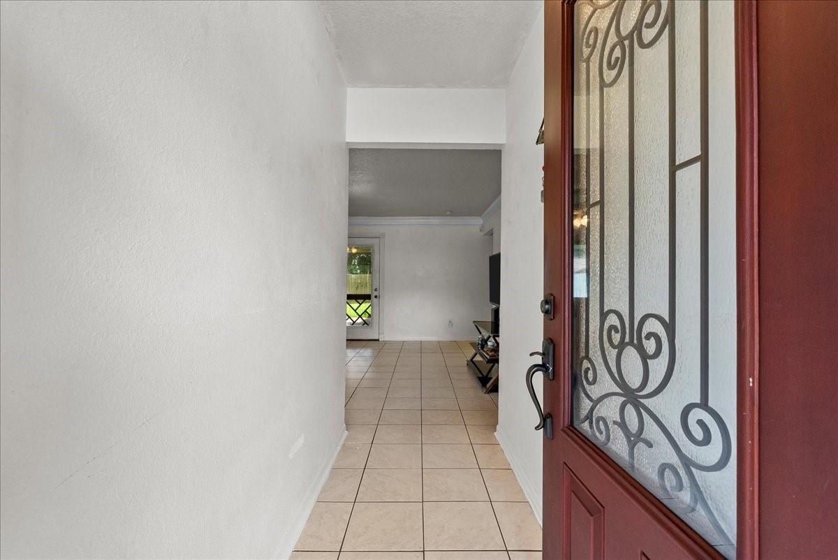 Image 4: Welcoming entryway leading into the open-concept l