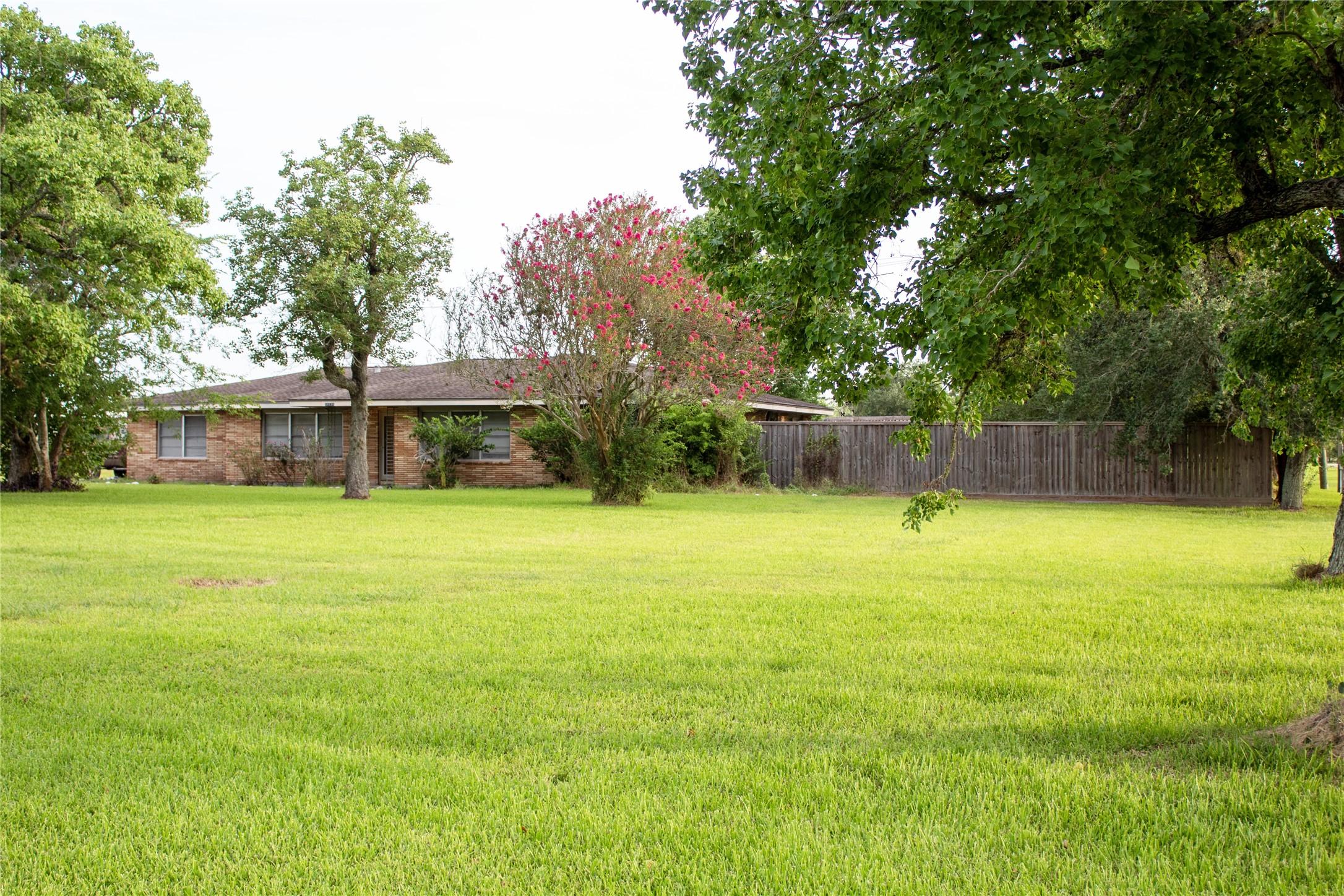 Image 1: front of house from corner of yard