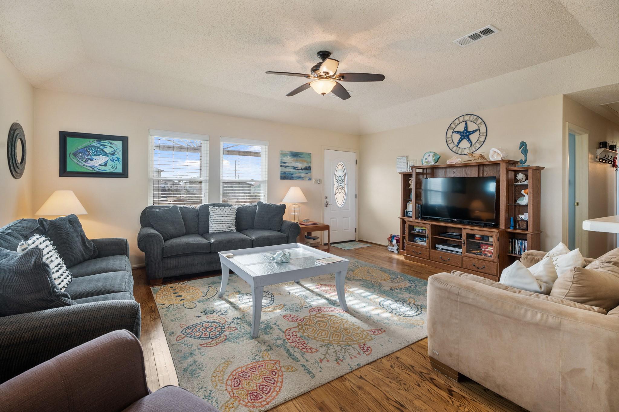 Image 4: The living room is spacious and inviting, featurin