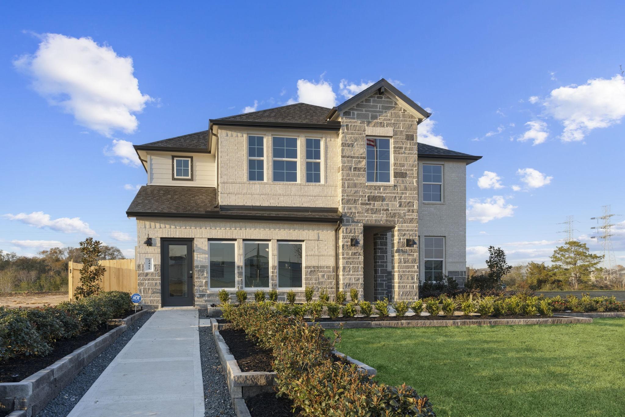 Image 2: This is the model modern two-story home with a mix