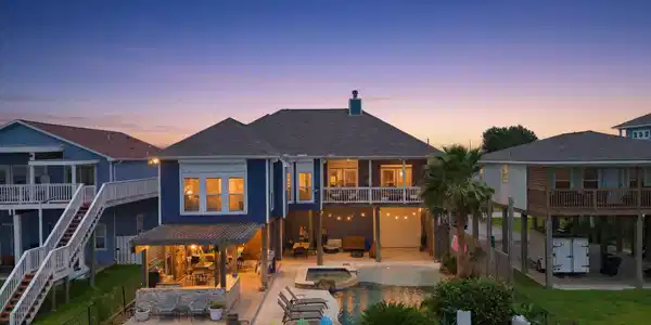 Image 2: Back View with Sparkling Pool and Outdoor Kitchen