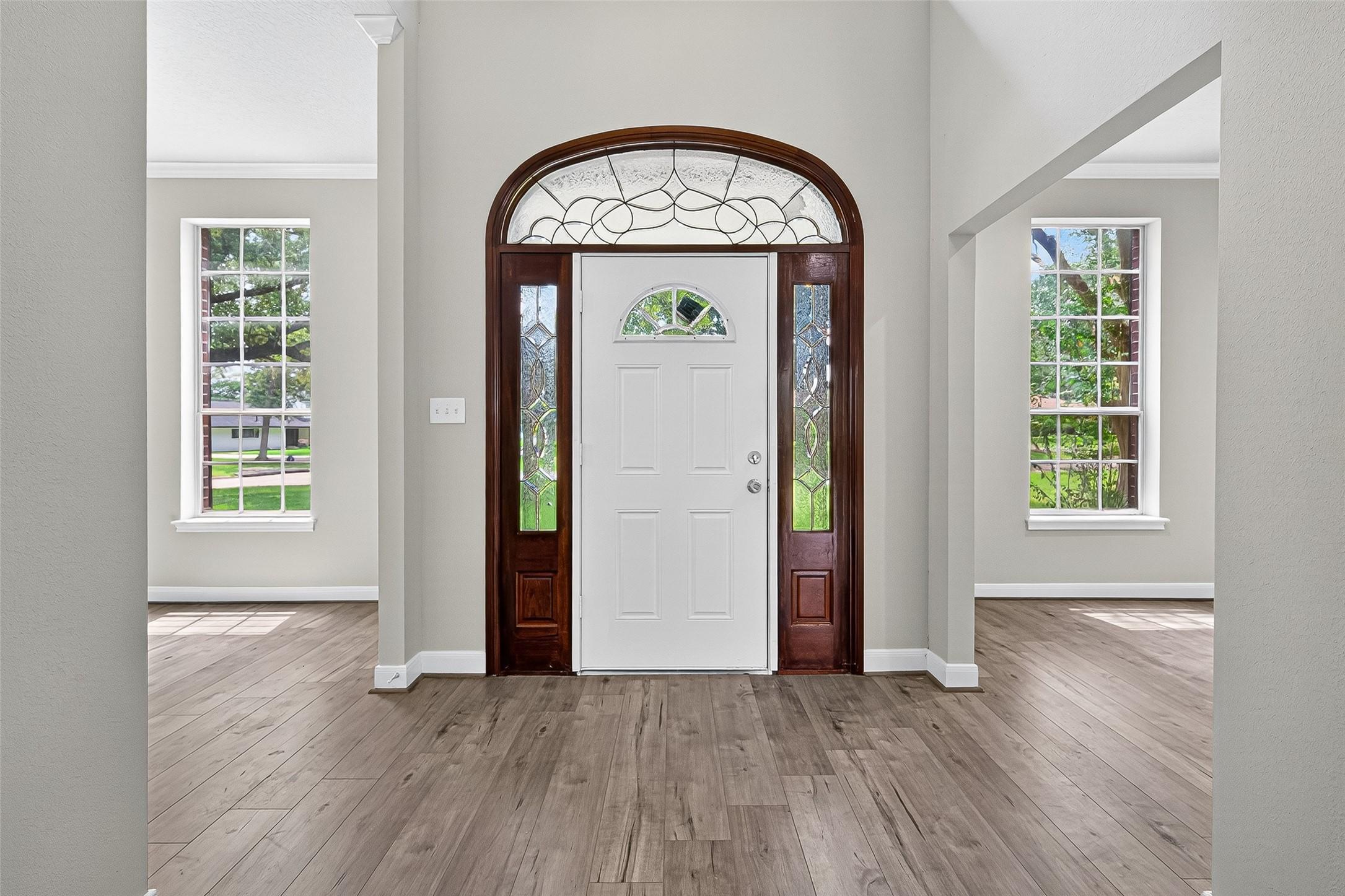 Image 4: Bright entryway featuring a white door with decora