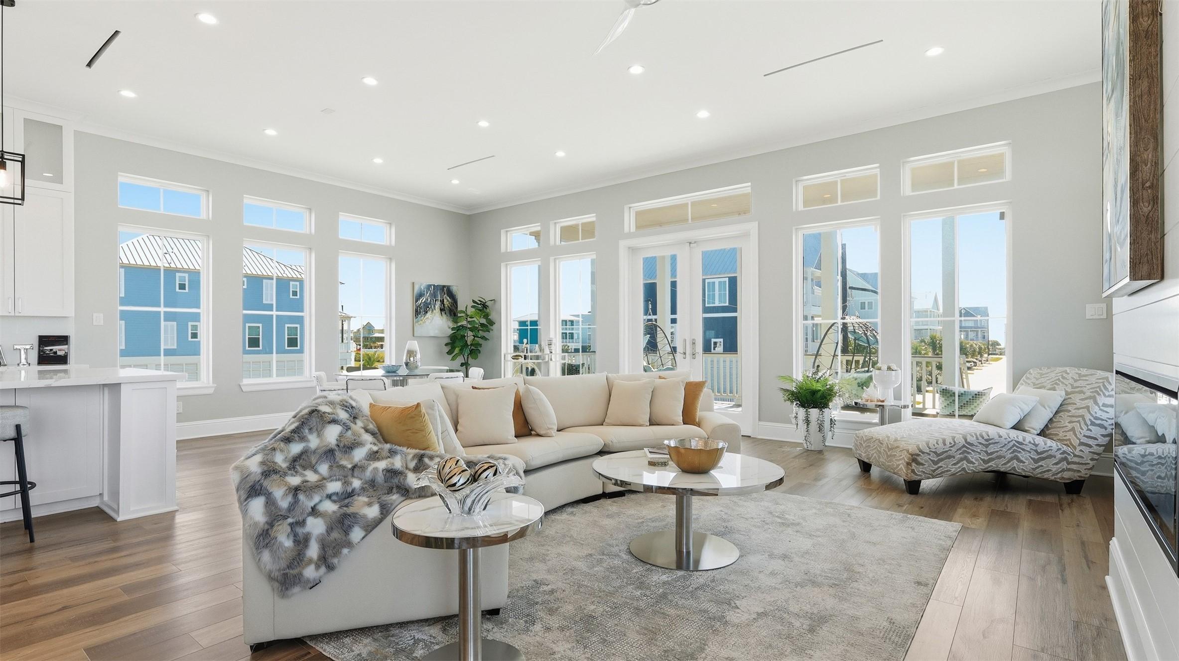 Image 1: This spacious, modern living room features abundan