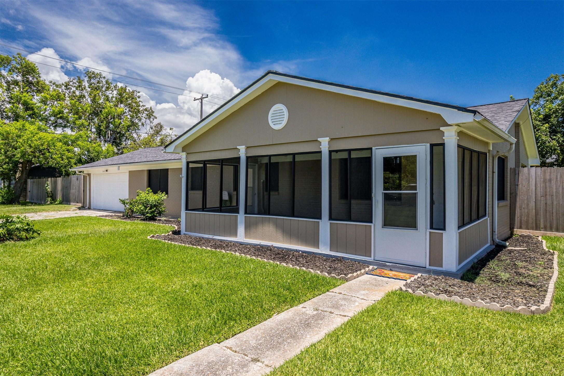 Image 1: This charming single-story home with a screened po