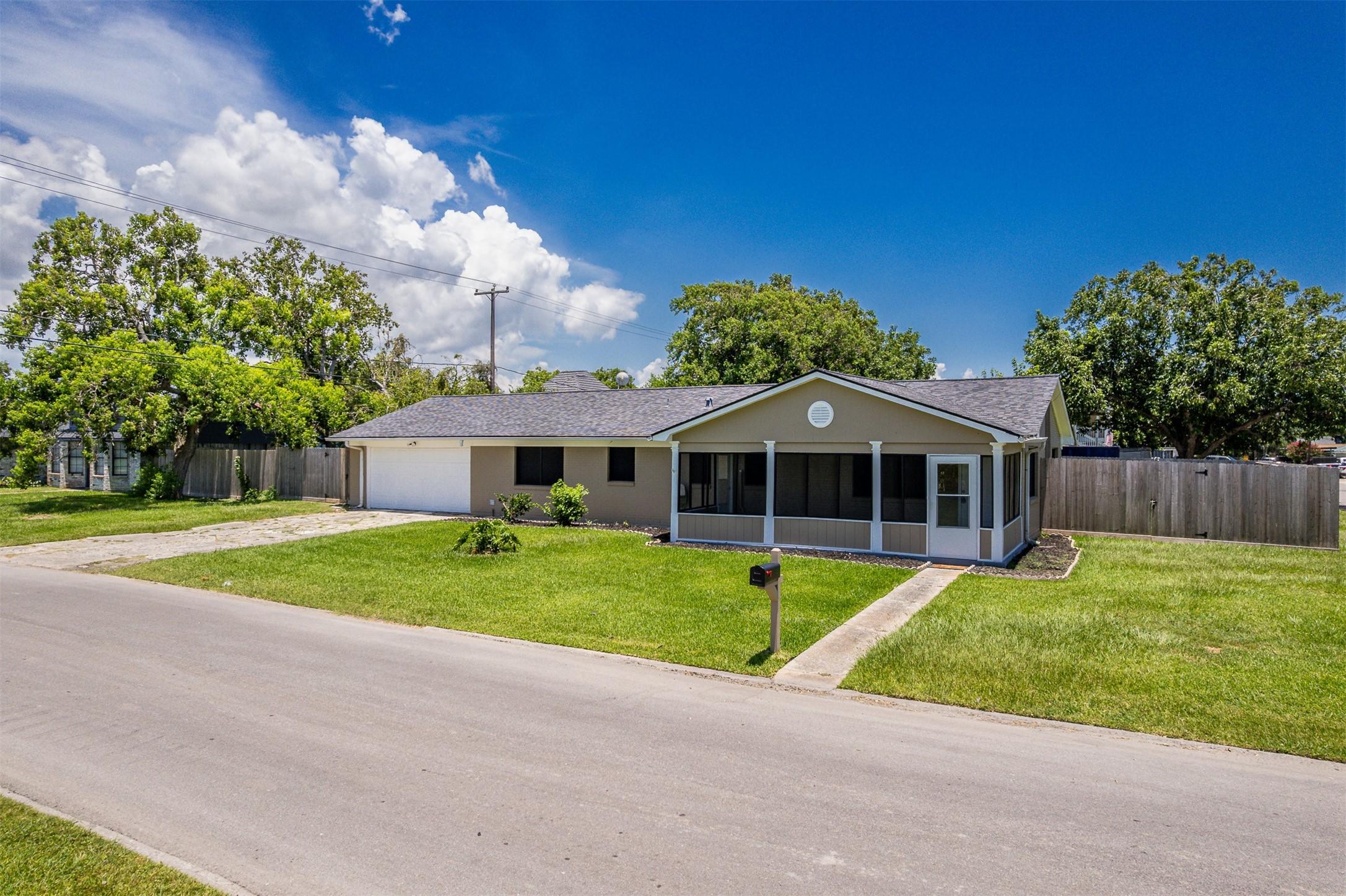 Image 2: This is a charming single-story home with a screen