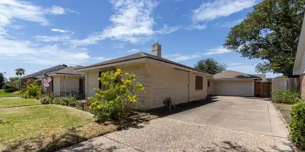 Image 3: Double car driveway leading to two car garage.