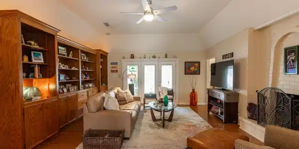 Image 4: Den view from the formal entry foyer. Fireplace wi