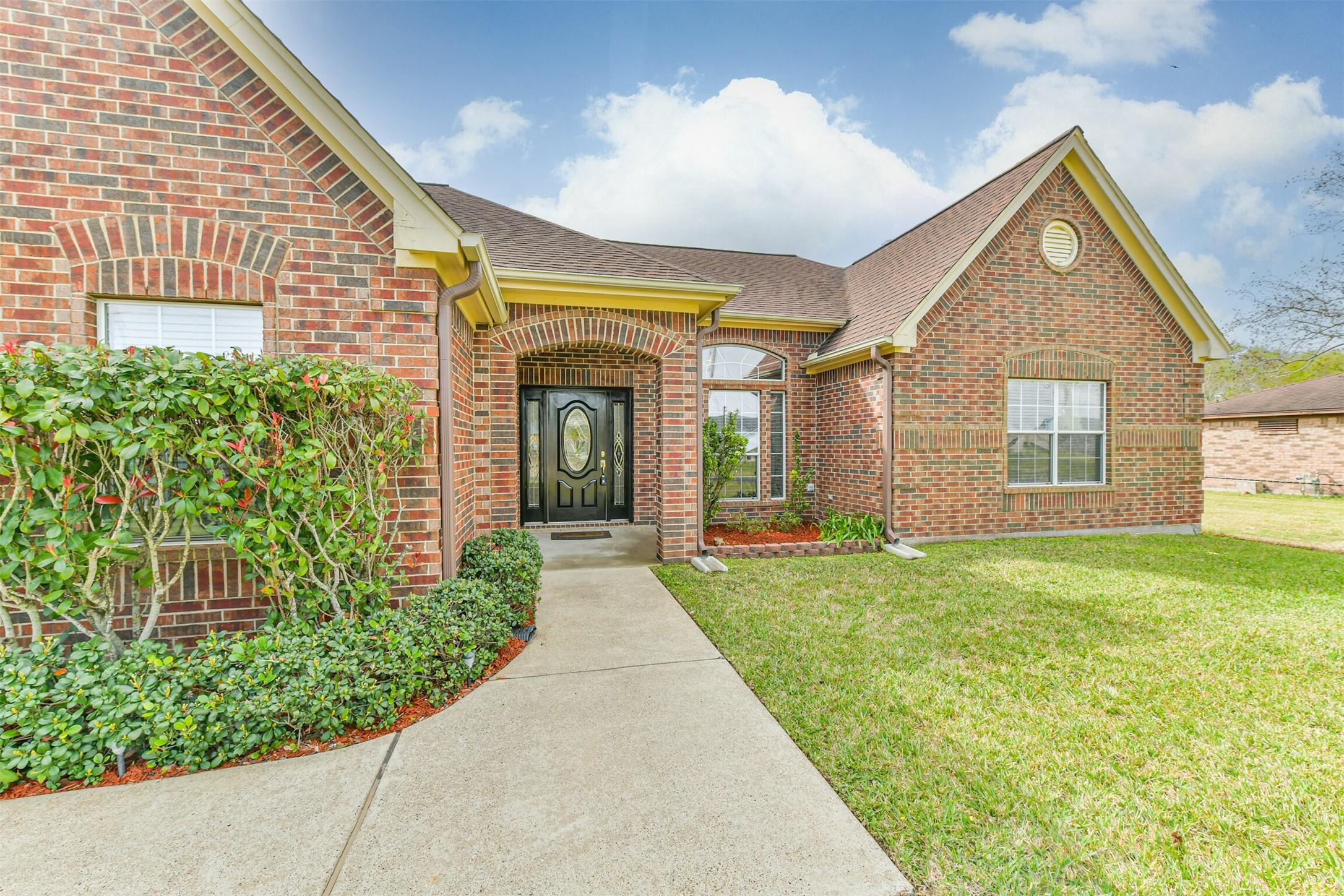 Image 2: Nicely landscaped yard and beautiful door offer gr