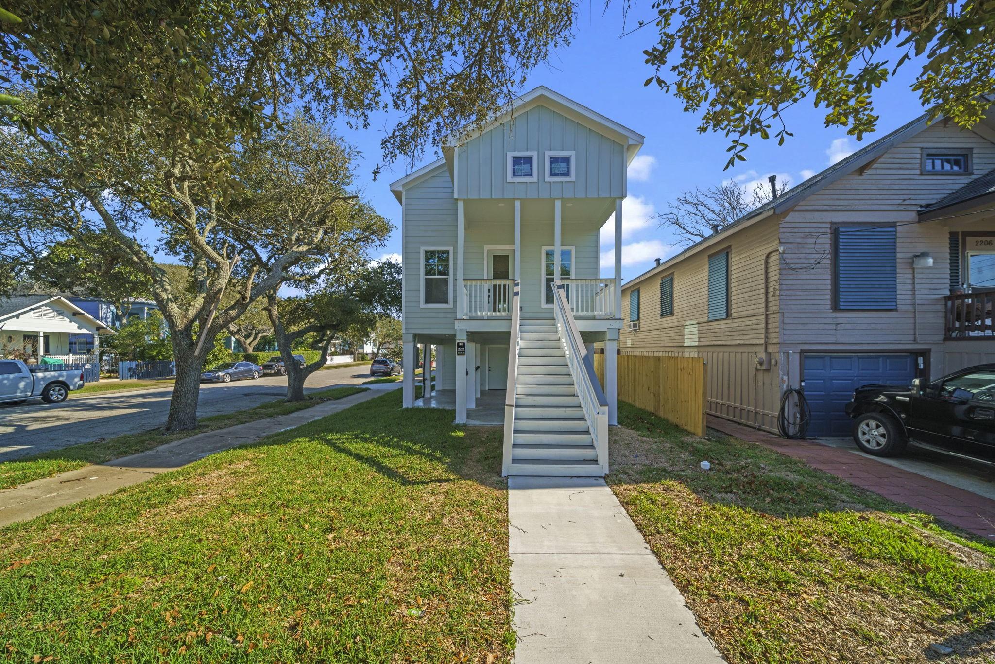 Image 2: Charming elevated home with a welcoming front stai
