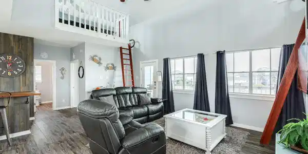 Image 4: Open-concept living area features soaring ceilings