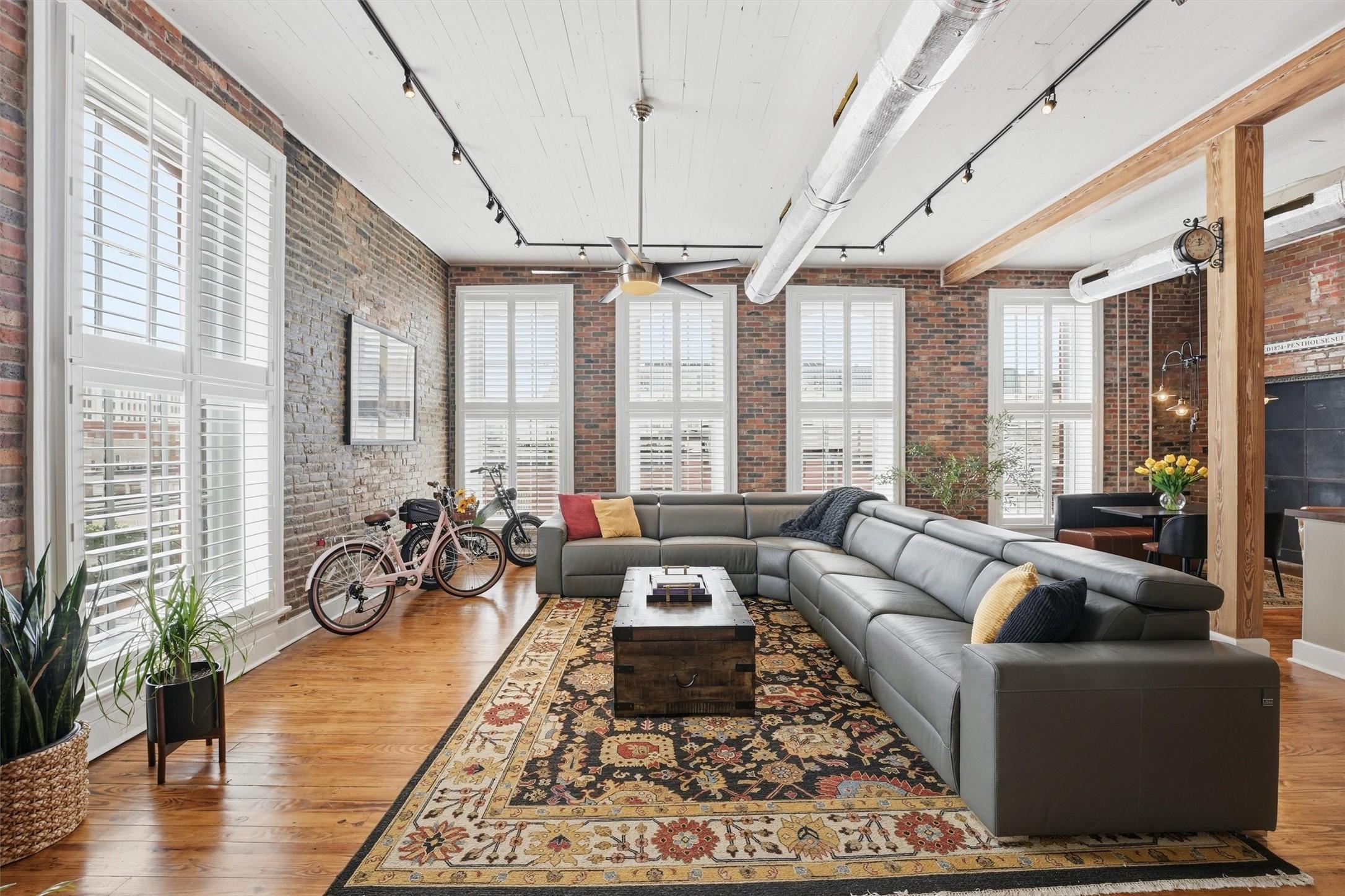 Image 4: Open-concept living space showcasing exposed brick