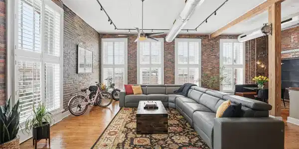 Image 4: Open-concept living space showcasing exposed brick