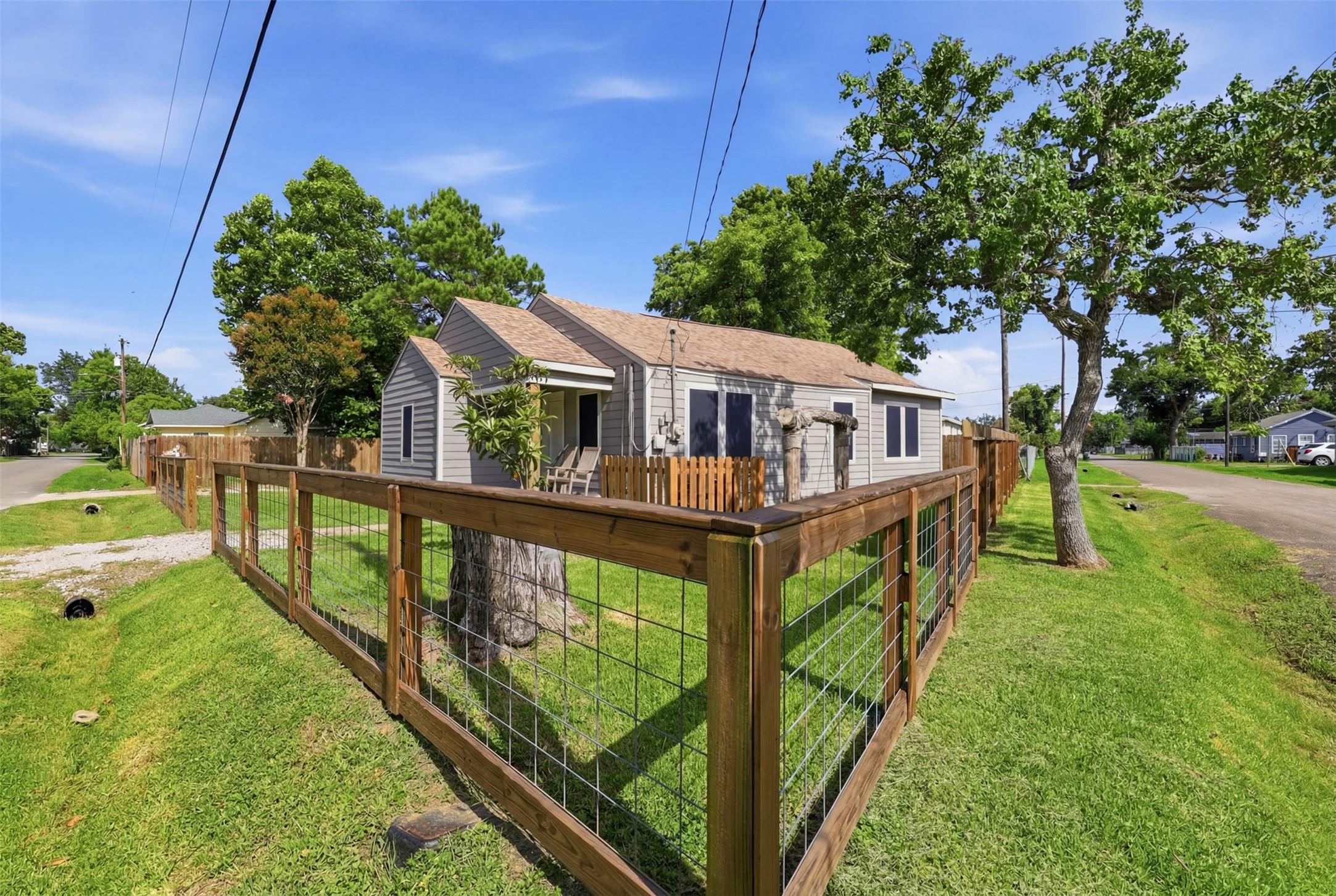 Image 4: Fully fenced corner lot with charming curb appeal.