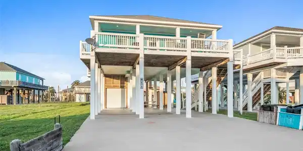 Image 3: Elevated coastal home with expansive covered parki
