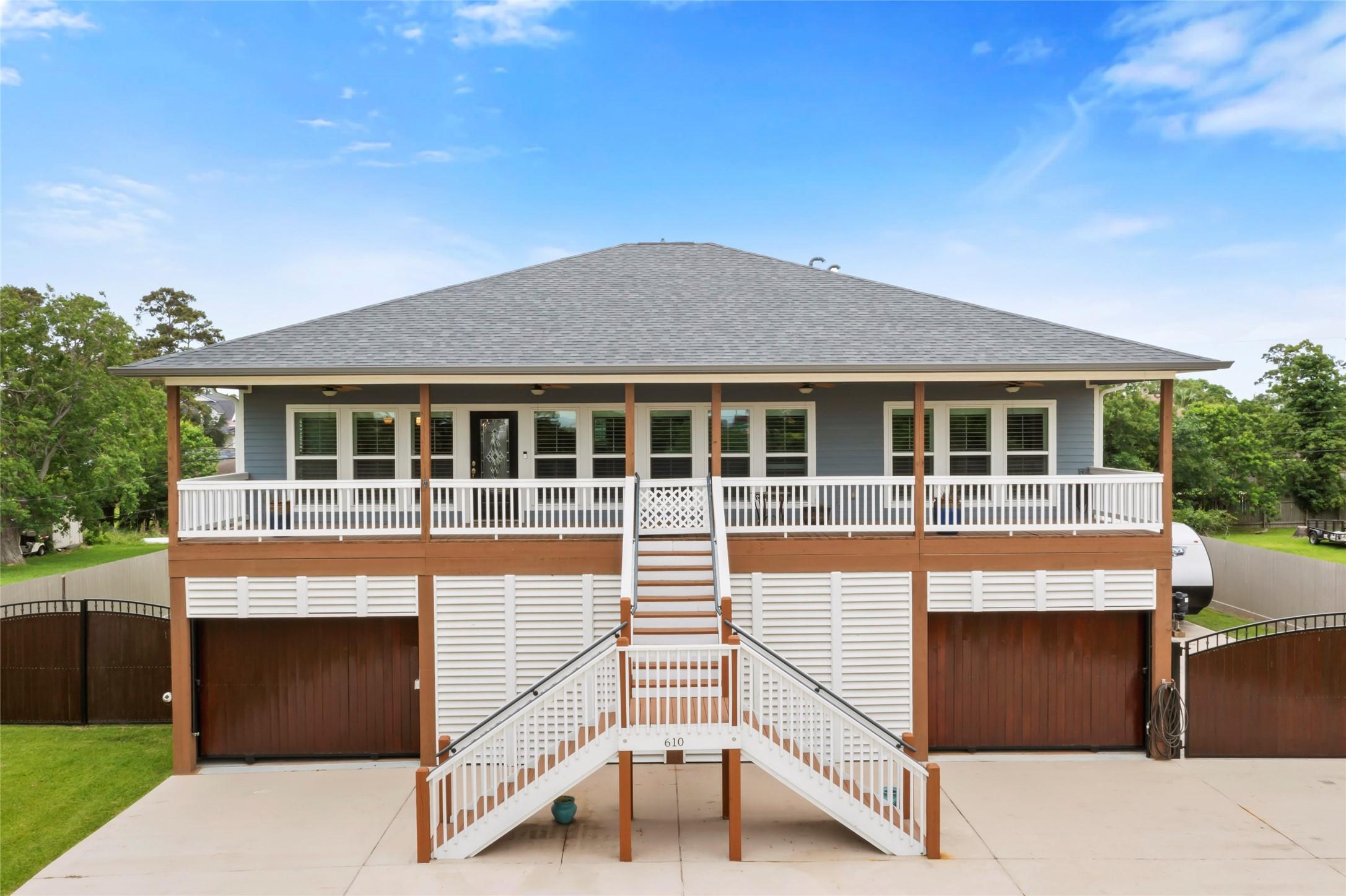 Image 3: This elevated home features a spacious front porch