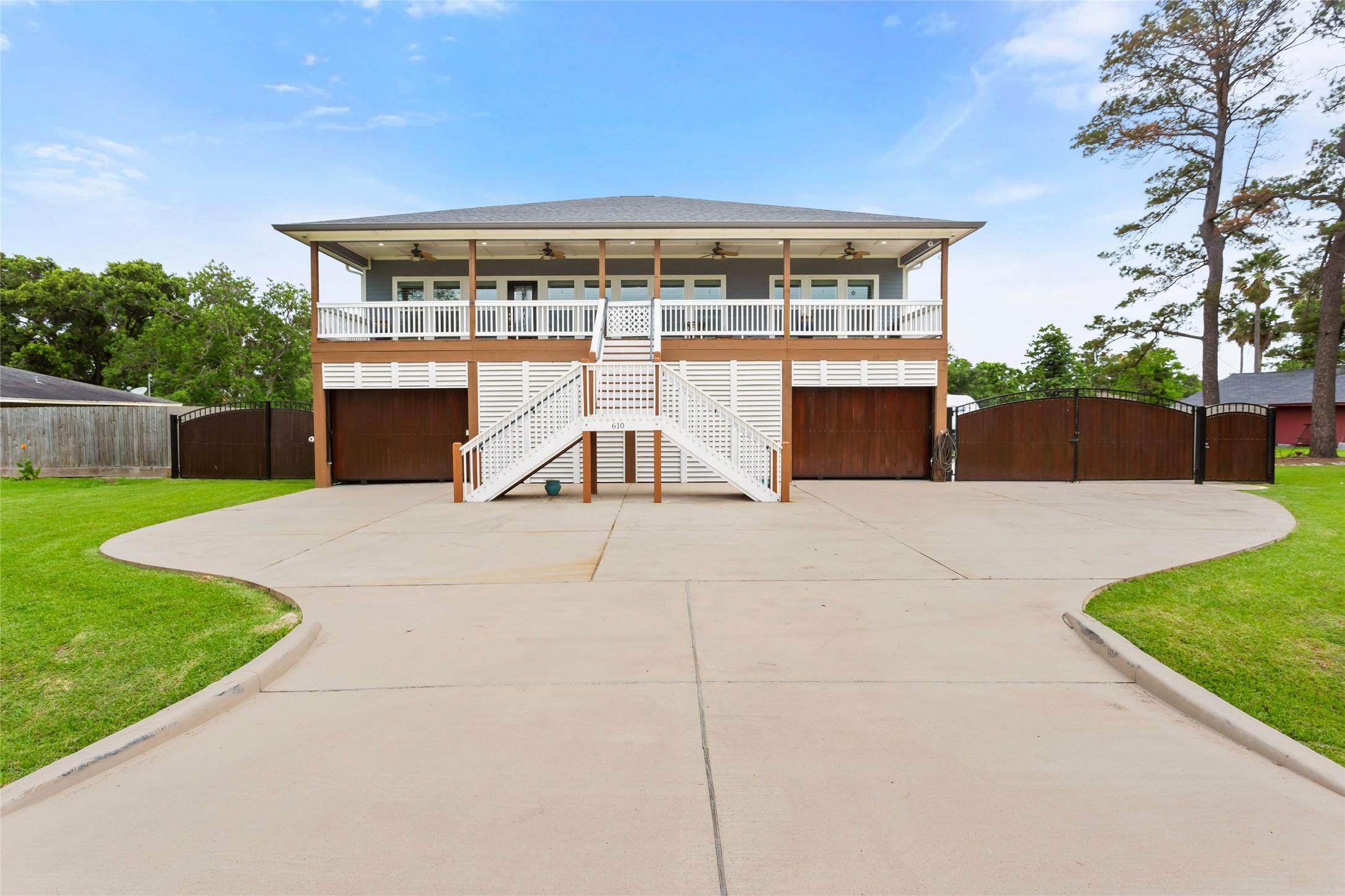 Image 4: This photo features a spacious two-story home with