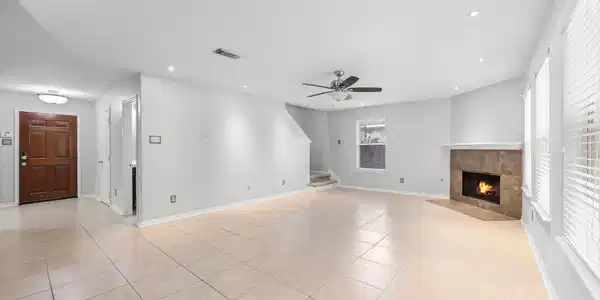 Image 4: Natural light from a wall of windows complements t