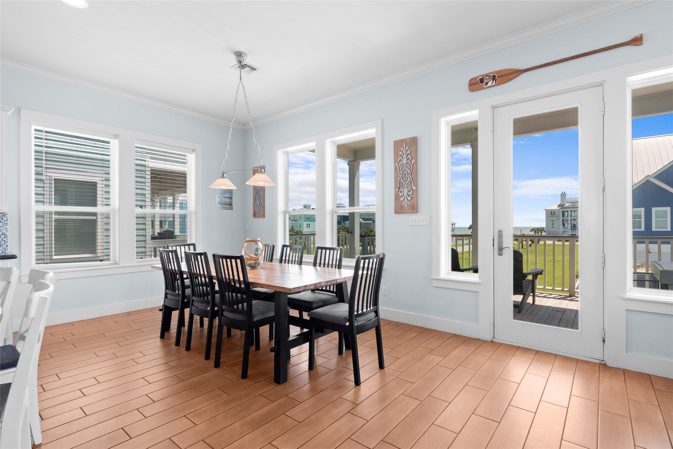 Image 3: This bright dining area features a spacious table