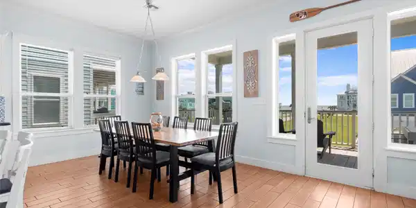 Image 3: This bright dining area features a spacious table