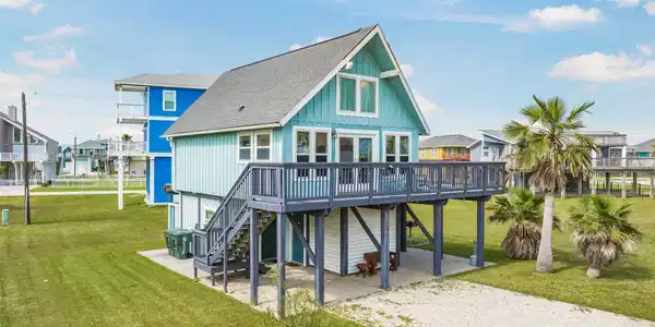 Image 3: This charming coastal home features elevated desig