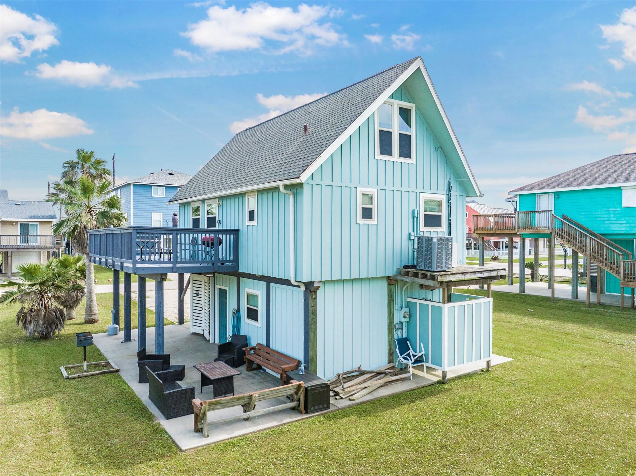 Image 4: This charming coastal home features a vibrant blue