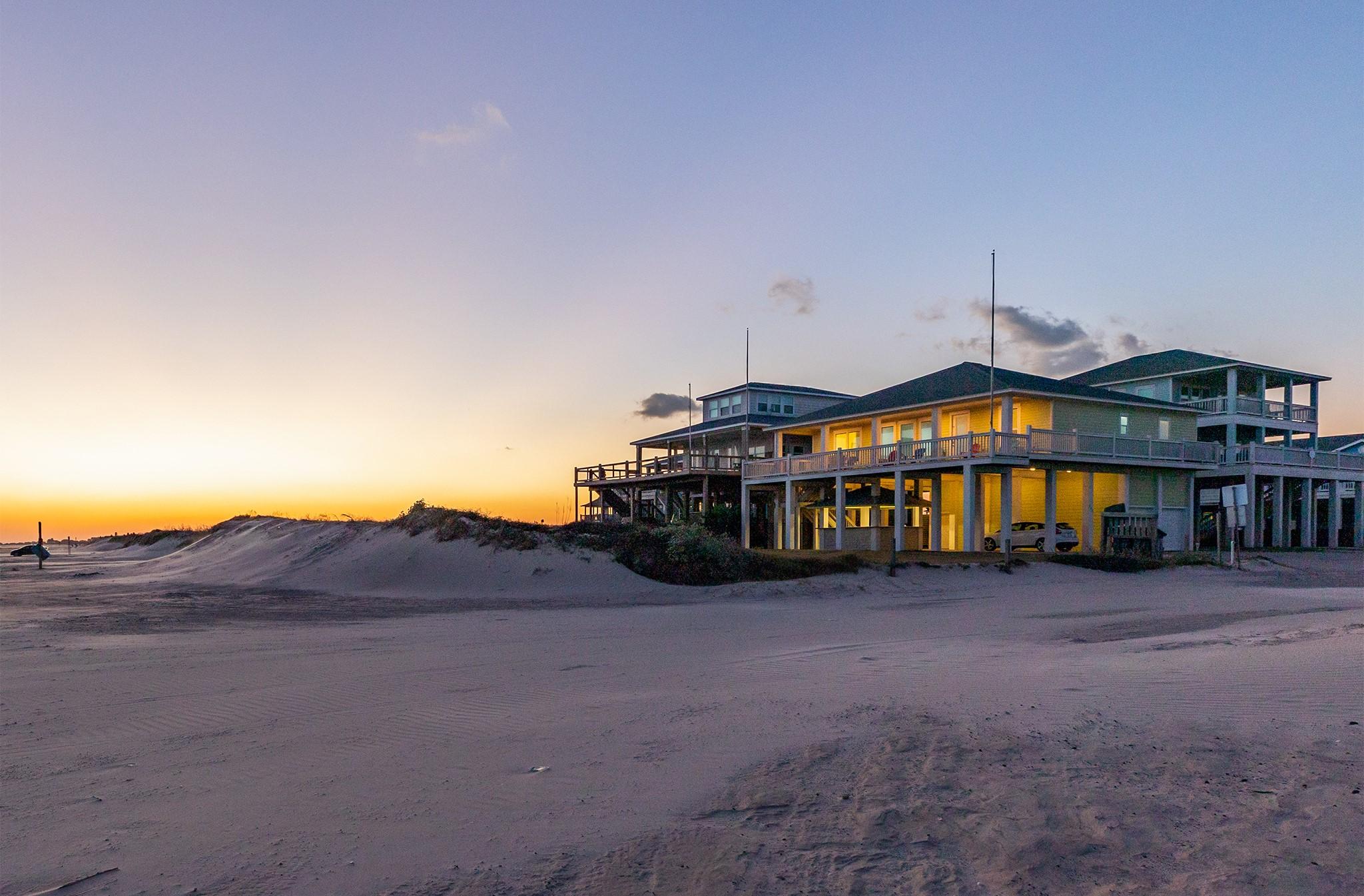 Image 1: Beachfront home with elevated design, featuring ex